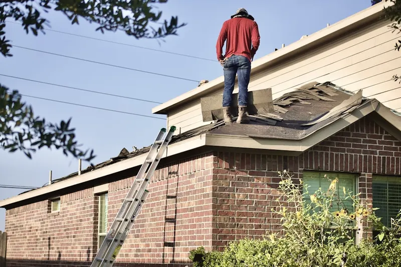 Professional roofer working on a residential roof in Marina
